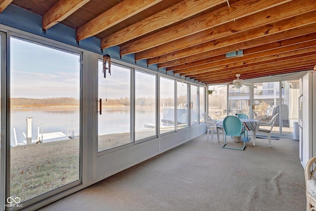 unfurnished sunroom with a water view