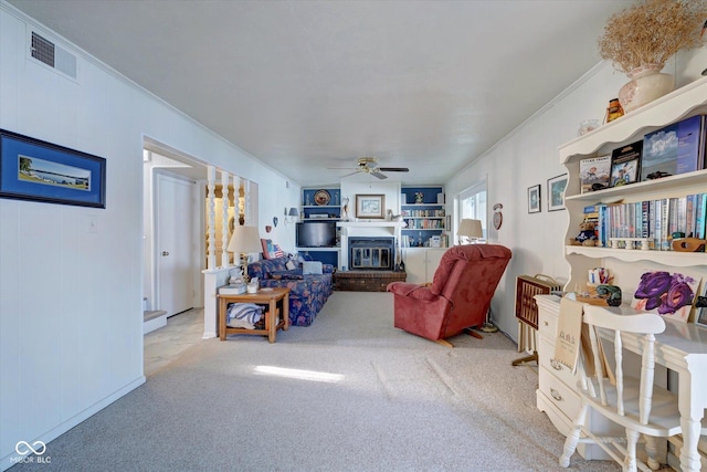 living room with crown molding, light colored carpet, and ceiling fan