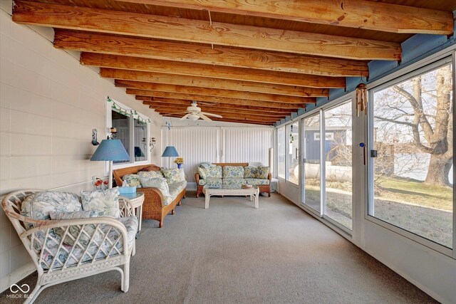 sunroom / solarium featuring beam ceiling