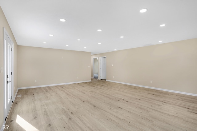 empty room with light hardwood / wood-style flooring