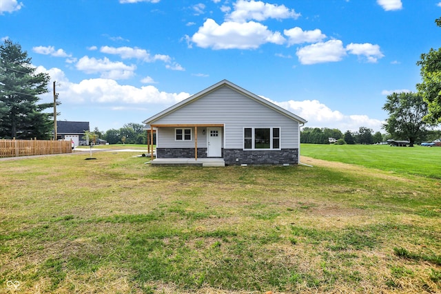 back of property featuring a lawn