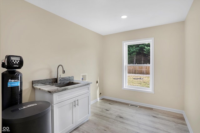 bathroom with sink and wood-type flooring