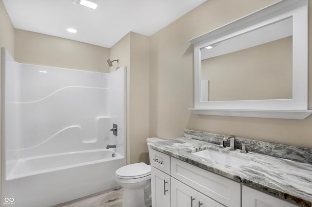 full bathroom featuring wood-type flooring,  shower combination, toilet, and vanity