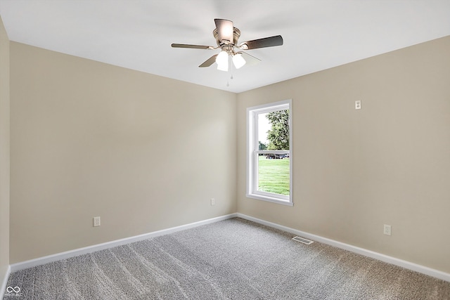 carpeted spare room featuring ceiling fan