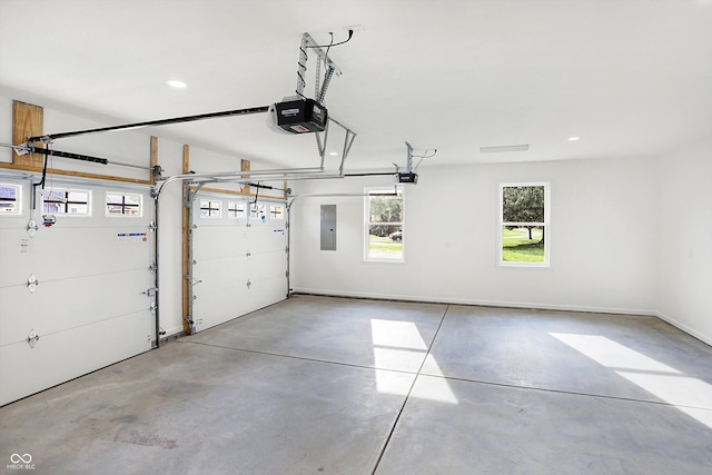 garage with a garage door opener and electric panel