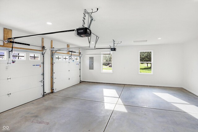 garage with electric panel and a garage door opener