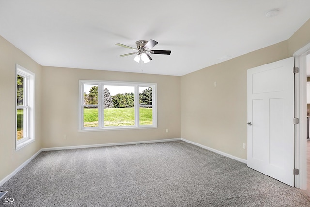 spare room with carpet floors and ceiling fan