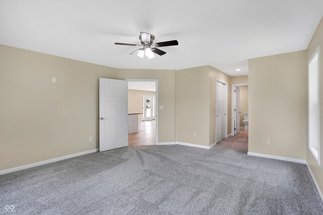 carpeted spare room with ceiling fan