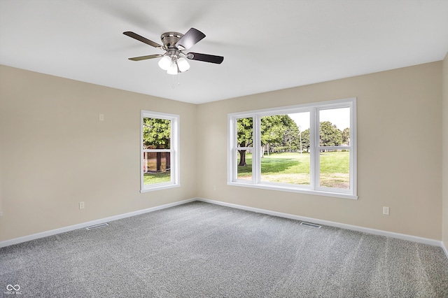 carpeted spare room featuring ceiling fan