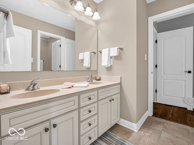 bathroom featuring double vanity and hardwood / wood-style flooring