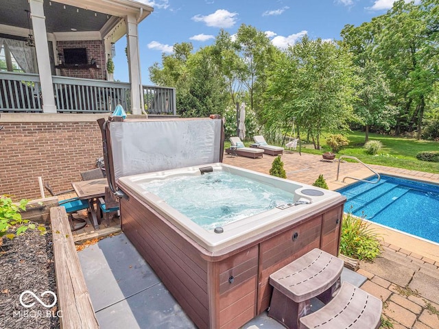 view of swimming pool featuring a hot tub