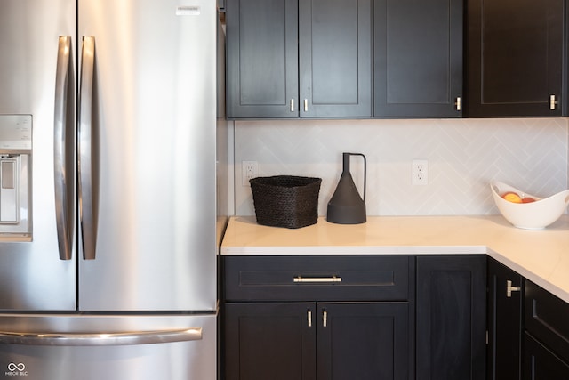 kitchen with decorative backsplash and stainless steel fridge with ice dispenser