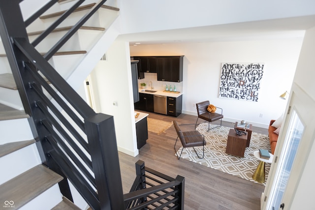 living room featuring sink and light hardwood / wood-style floors