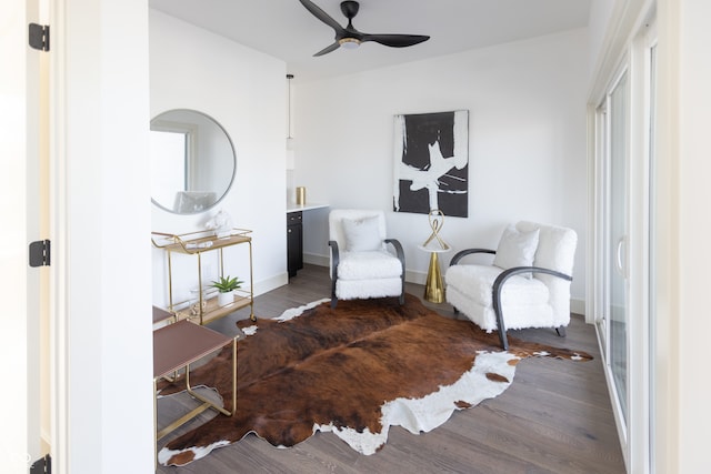 living area featuring ceiling fan and hardwood / wood-style floors