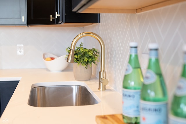 details featuring decorative backsplash and sink