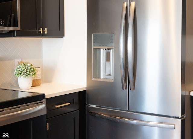 kitchen featuring appliances with stainless steel finishes and tasteful backsplash