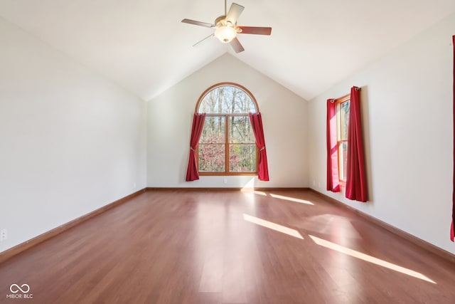 unfurnished room featuring vaulted ceiling, hardwood / wood-style flooring, and ceiling fan