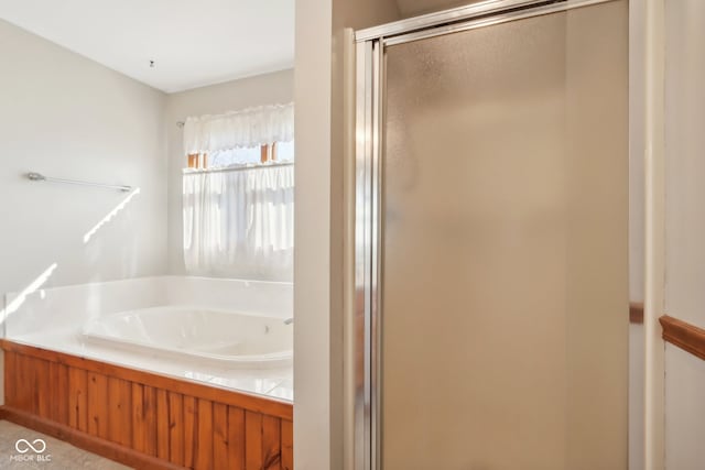 bathroom with shower with separate bathtub