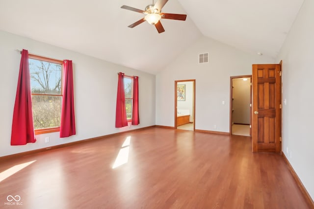 unfurnished room featuring hardwood / wood-style flooring, ceiling fan, and high vaulted ceiling