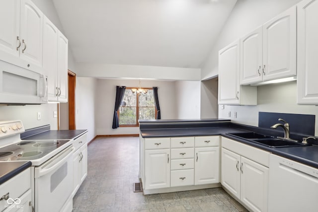 kitchen featuring white cabinetry, kitchen peninsula, sink, vaulted ceiling, and white appliances