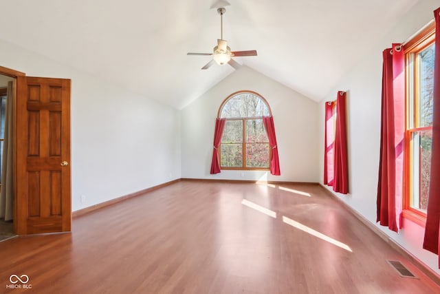 spare room with hardwood / wood-style floors, lofted ceiling, and ceiling fan