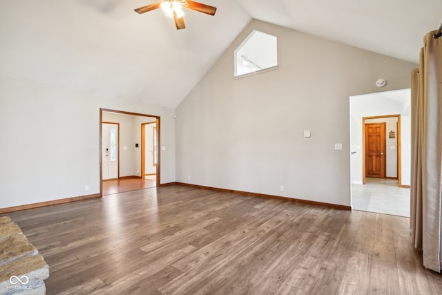 unfurnished living room featuring high vaulted ceiling, hardwood / wood-style floors, and ceiling fan