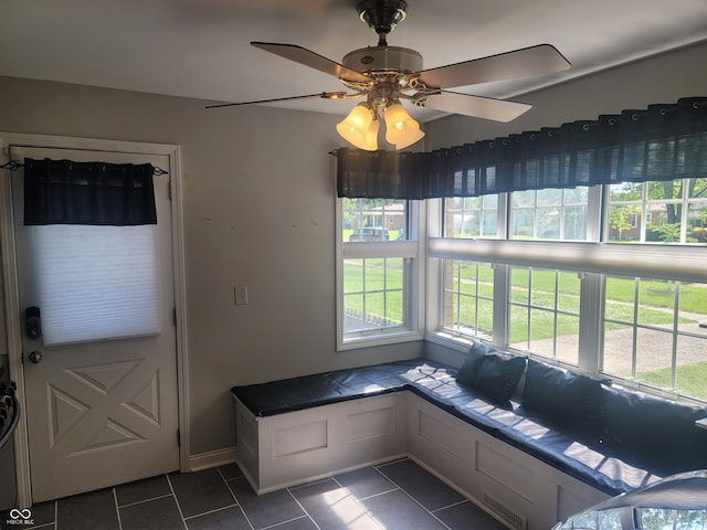 interior space featuring dark tile patterned flooring and ceiling fan