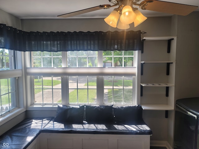 unfurnished living room featuring ceiling fan and a wealth of natural light