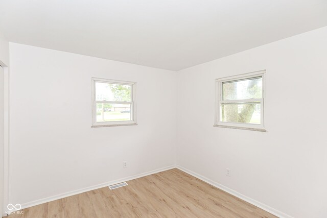 spare room featuring light wood-type flooring