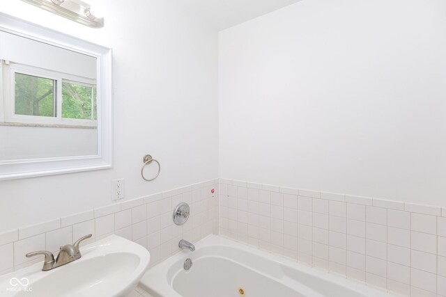 bathroom featuring a tub and sink