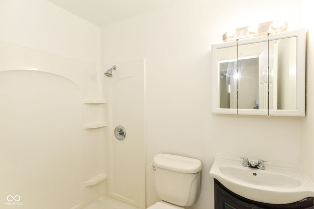 bathroom featuring a shower, vanity, and toilet