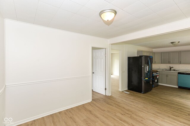 kitchen with gray cabinetry, light hardwood / wood-style flooring, dishwasher, and black refrigerator with ice dispenser