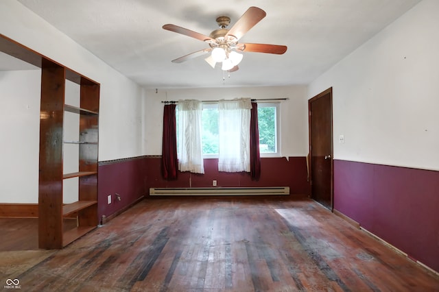 spare room featuring ceiling fan, wood-type flooring, and a baseboard heating unit