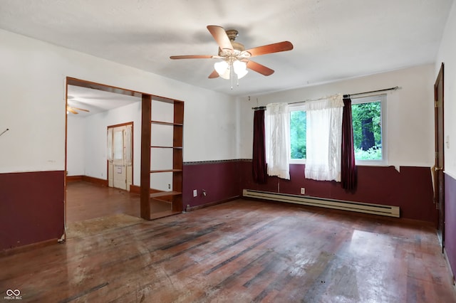 empty room featuring hardwood / wood-style flooring, baseboard heating, and ceiling fan