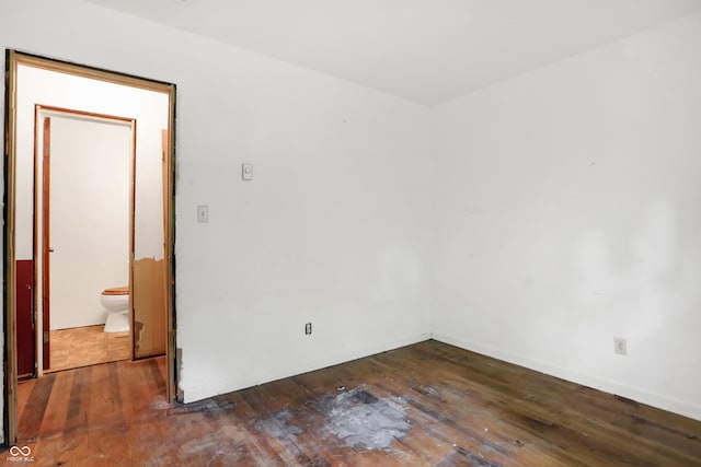 unfurnished room with dark wood-type flooring