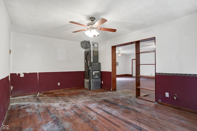 unfurnished room with heating unit and ceiling fan