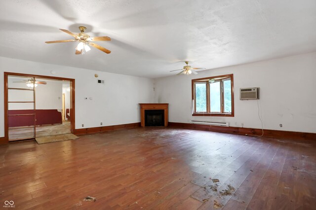 unfurnished living room featuring an AC wall unit, wood-type flooring, baseboard heating, and ceiling fan