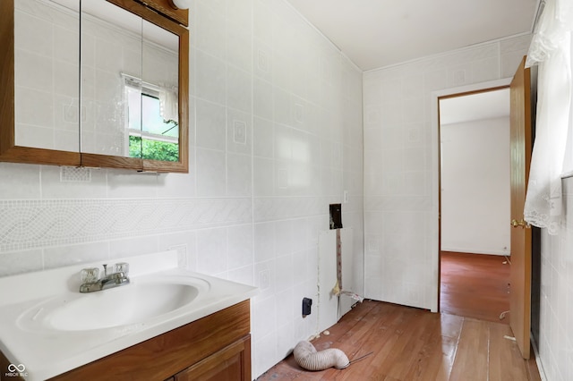 bathroom with vanity, tile walls, and hardwood / wood-style flooring