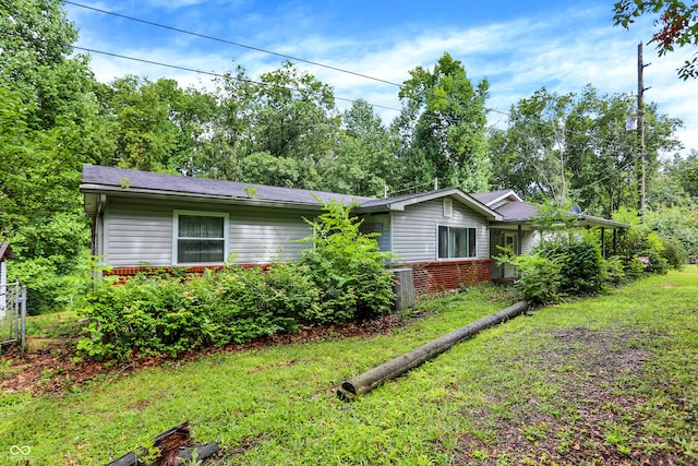 view of side of home with a yard