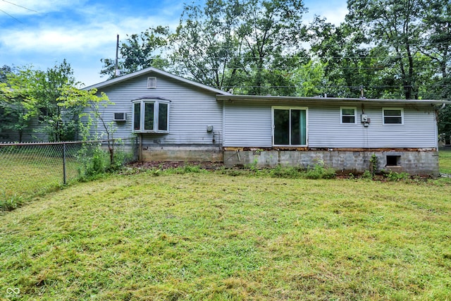 rear view of property featuring a yard