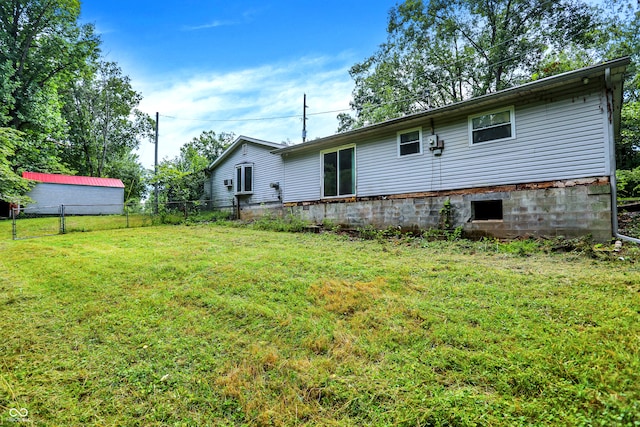 back of property with a lawn