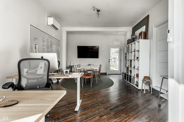 living room featuring track lighting, dark hardwood / wood-style floors, and a wall mounted AC