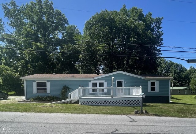 view of front of property featuring a front lawn and a wooden deck