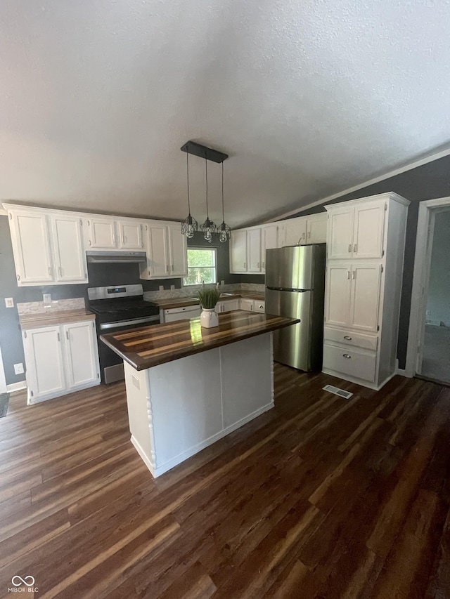 kitchen with appliances with stainless steel finishes, dark hardwood / wood-style flooring, a kitchen island, and white cabinets