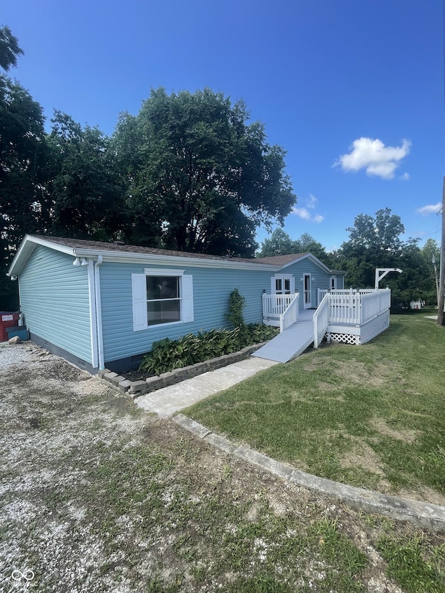 view of front of property with a front lawn and a deck