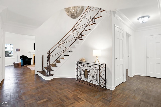 staircase with parquet floors and ornamental molding