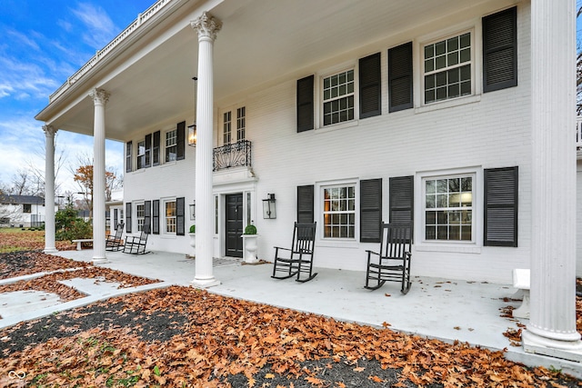 rear view of property with covered porch