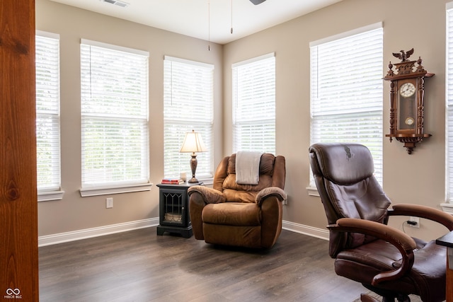 living area with ceiling fan and dark hardwood / wood-style flooring