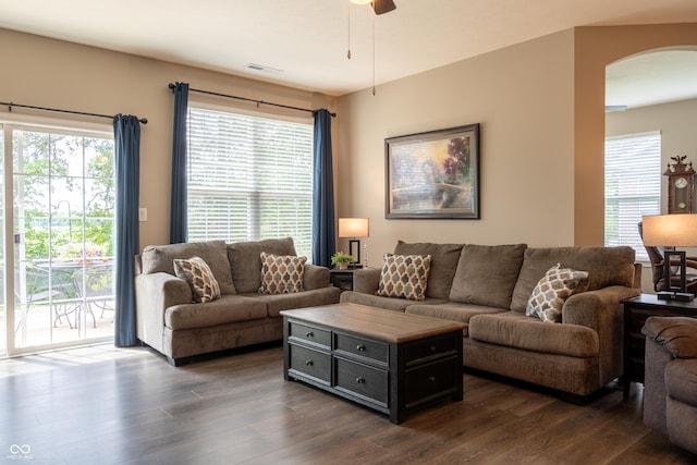 living room featuring plenty of natural light and dark hardwood / wood-style floors