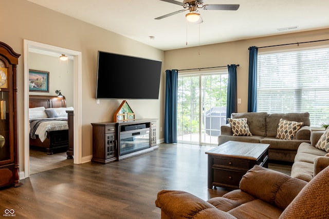 living room with dark hardwood / wood-style floors and ceiling fan